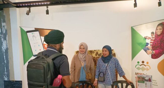 A visitor at MY Voice’s booth